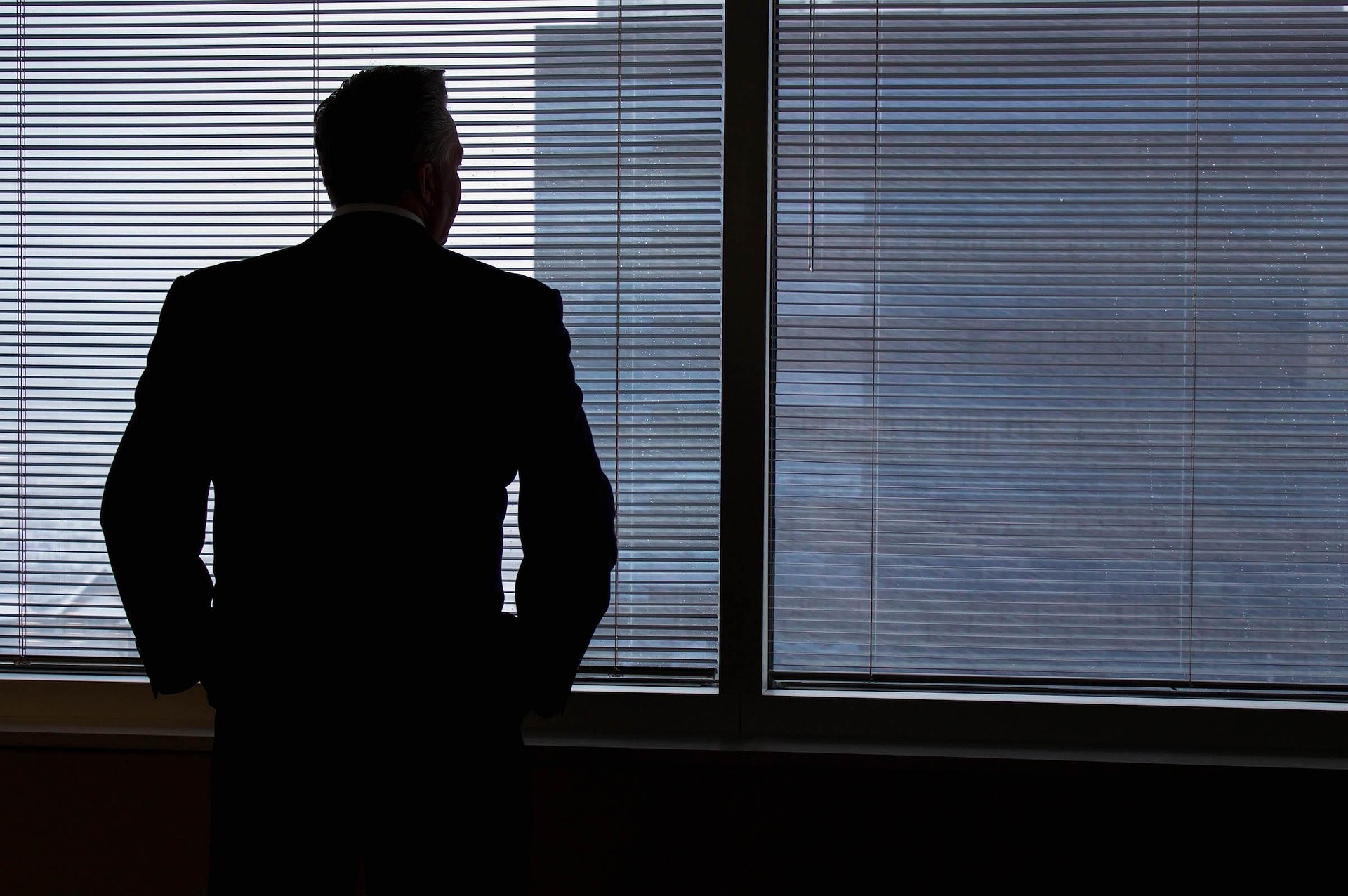 Executive looking out of an office window